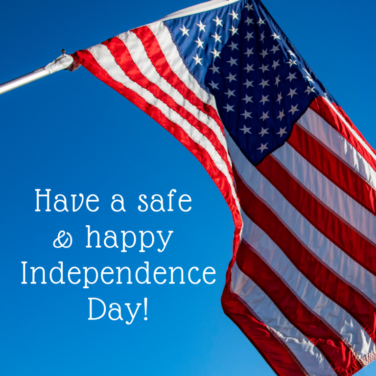 Have a safe and happy Independence Day! over still blue sky background with wind-blown American flag